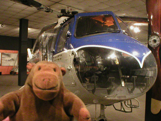 Mr Monkey in front of a Bristol Sycamore helicopter