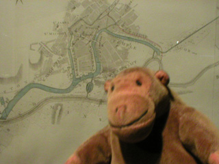 Mr Monkey examining a plan of Bristol Docks