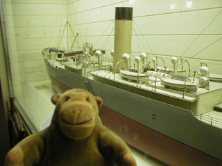 Mr Monkey with a model of a banana boat