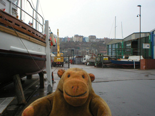 Mr Monkey passing a boat being repaired near the Bristol Marina