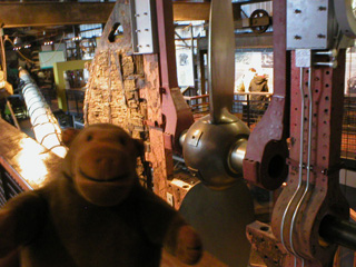 Mr Monkey looking at the screw raising gear in the museum