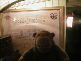 Mr Monkey looking at a plan of the ship