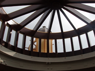 The ship's wheel viewed through the circular skylight on promenade deck