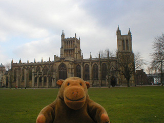 Mr Monkey looking at Bristol Cathedral across College Green