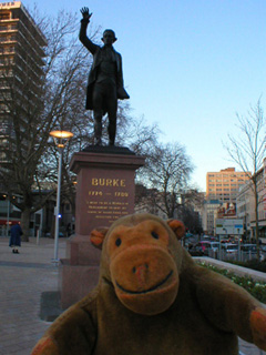 Mr Monkey looking at a statue of Burke