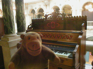 Mr Monkey looking at a historic piano