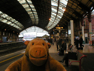 Mr Monkey waiting for a train at Temple Meads station