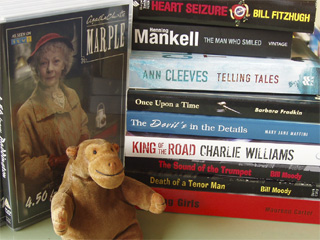 Mr Monkey in front of a fine selection of books