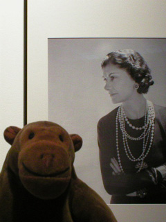 Mr Monkey with a picture of Coco Chanel