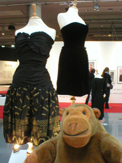 Mr Monkey examining Zandra Rhodes and Bruce Oldfield dresses