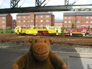 Mr Monkey looking at railway engineering equipment at Chester