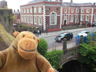 Mr Monkey looking down on the Northgate bridge over the canal