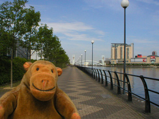 Mr Monkey looking along Wharfside Promenade towards the Lowry footbridge