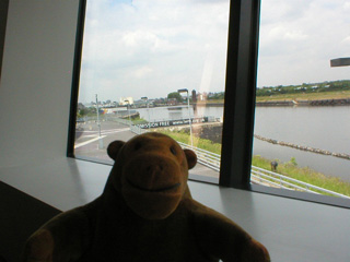 Mr Monkey looking out of the window of the Water Shard cafe