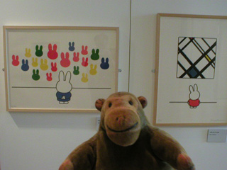Mr Monkey in front of pictures of Miffy visiting an art gallery