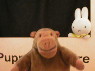 Mr Monkey watching Miffy in a puppet theatre