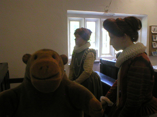 Mr Monkey looking at mannequins of the two sisters