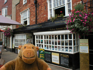 Mr Monkey outside Ye Oldest Chymists Shoppe in England