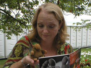 Mr Monkey looking at a programme with Stella Duffy