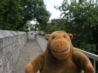 Mr Monkey walking along the wall towards Robin Hood's tower