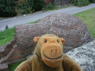 Mr Monkey looking down on an ice house from the city walls