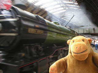 Mr Monkey watching a steam engine pass him