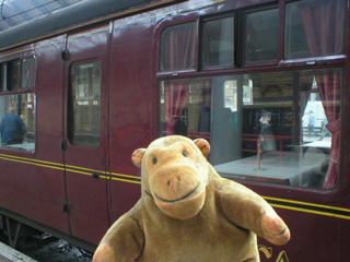 Mr Monkey looking in through the windows of his carriage
