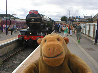 Mr Monkey walking away from the Green Arrow at Scarborough Station