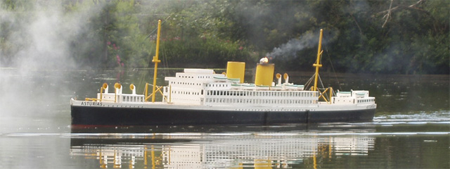 The Asturias, with a small flame burning in its second funnel