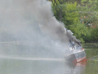 The enemy battleship keeling over, emitting black smoke