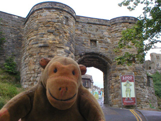 Mr Monkey outside the barbican gatehouse of Scarborough castle