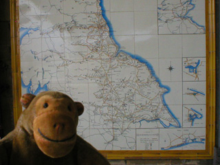 Mr Monkey examining a tile map of the North Eastern Railway
