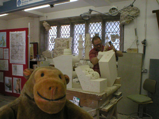 Mr Monkey watching a carver work some stone