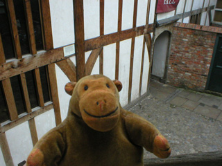 Mr Monkey looking down from the top of the external staircase of Barley Hall