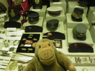 Mr Monkey studying a display of military headwear