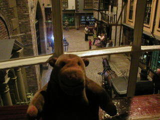 Mr Monkey looking at reconstructed street from an upstairs window