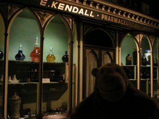 Mr Monkey outside a chemist's shop