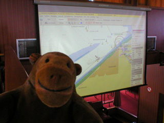 Mr Monkey looking at a map of the ship's position