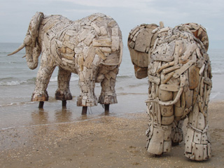 Two elephants walking into the sea