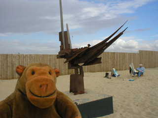 Mr Monkey examining a sculpture at De Panne