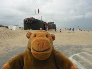 Mr Monkey looking at a beached barge