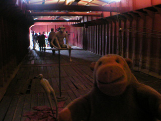 Mr Monkey looking at figures inside the barge