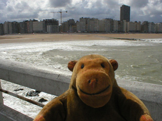 Mr Monkey looking at Ostende beach from the pier