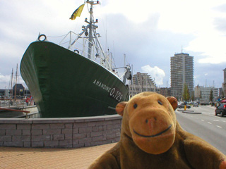 Mr Monkey looking at the bows of a trawler in dry dock
