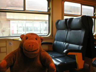Mr Monkey aboard a train to Ghent