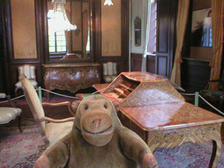 Mr Monkey looking at a period room at the Design Museum