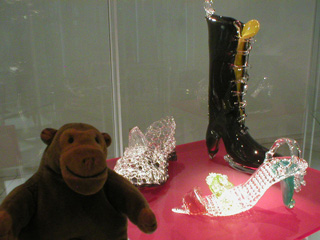 Mr Monkey looking at some glass shoes