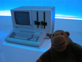 Mr Monkey studying an IBM personal computer from the 1980s