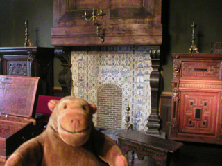 Mr Monkey in a period room with a fine fireplace