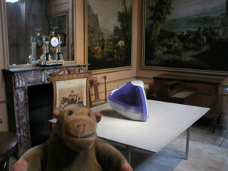 Mr Monkey in a period room with am Imac on a table